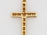 a close up of a gold cross on a white surface