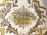 an image of a white and gold cloth with a sun on it