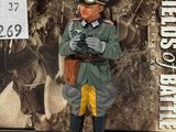 a figurine of a man in uniform holding a gun