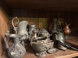 many different types of vases on a shelf