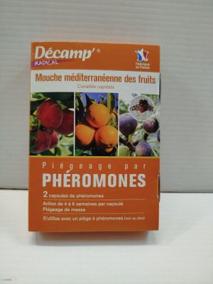 an orange book sitting on top of a table next to a white wall
