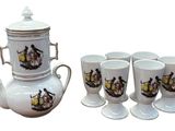 four cups and a teapot sitting next to each other