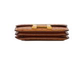 an image of a brown leather wallet with a gold clasp