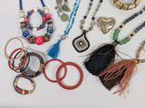 a lot of different necklaces and bracelets on the table