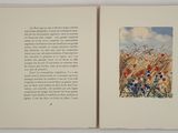 an open book with a picture of a field of flowers on it