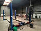 a picture of a garage with a lot of tools on the floor