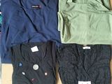 three pairs of men ' s t - shirts in a box on a table