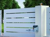 a white fence that has a mailbox on it