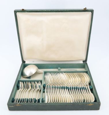 a box with silverware in it on a white surface