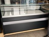 a man that is standing in front of a display case