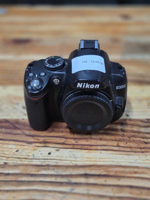 a black camera sitting on a wooden table