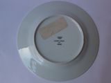 a white plate with a piece of paper on it