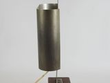 a metal lamp that is on a wooden stand