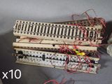 a lot of small wooden train tracks with wires on them