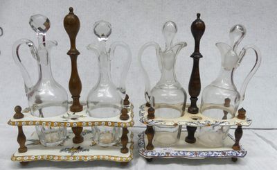 four glass decanters and a wooden stand on the table