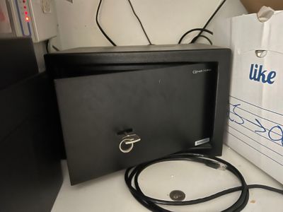 an image of a microwave oven with a cord in front of it