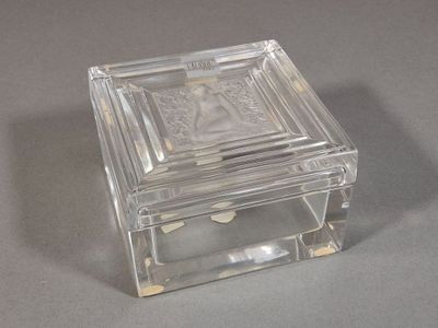 a glass box with a picture on it on a table