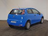 a picture of a small blue car parked in a room