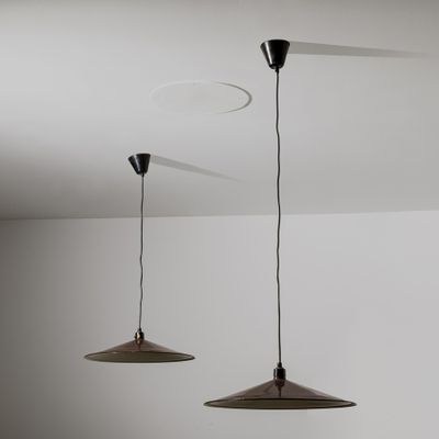 two lights hanging from the ceiling in a room