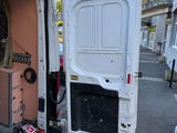 a white van with a door open on the street