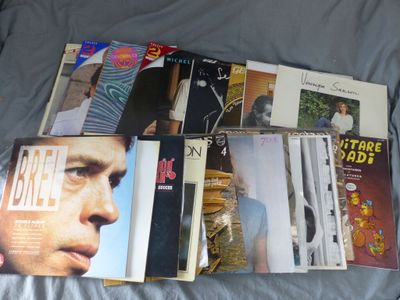 a lot of cds on a bed with a blue comforter