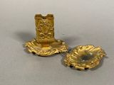 two gold objects that are sitting on a table