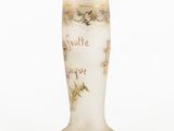 a white vase with a gold rim and a quote on it