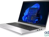 the laptop is open on a white surface with a blue background