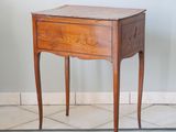 a small wooden table with a drawer on top of it