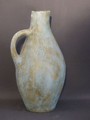 a large green vase with a handle on a gray background