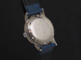 a close up of a watch on a black surface