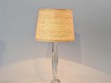 a lamp that is sitting on a table with a lamp shade on it