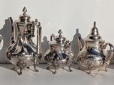 a lot of silver objects that are on the table