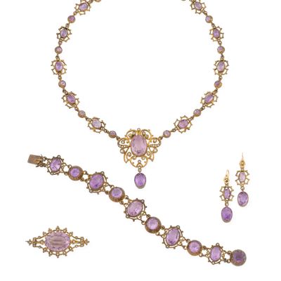 un gros plan d'un collier et de boucles d'oreilles sur fond blanc