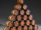 wooden wine barrels stacked on top of each other in a pyramid