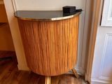 a wooden table with a glass top in the corner of a room