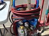 a cart with a bunch of gas bottles and hoses