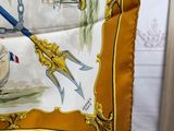 a yellow scarf with a picture of a sailboat on it