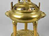 an antique brass incense burner with a rooster on top