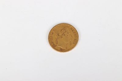 a gold coin sitting on top of a white surface