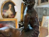 a statue of a boy riding a horse in a room