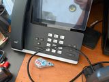 a desk with a phone, a printer, and other office supplies on it