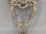 an antique console table with a marble top and ornate carvings