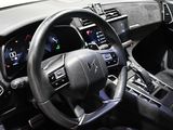 the interior of a car with a steering wheel and dashboard controls