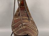 a sculpture of a boat with a hat on it ' s head