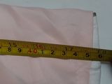 someone is measuring the length of a pillow with a tape