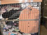 a metal cage with a suitcase on top of it