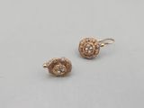 a pair of gold and diamond earrings