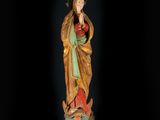 a wooden statue of the virgin of guadalupe