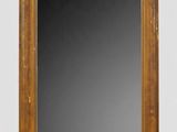an antique mirror with a wooden frame on a white background